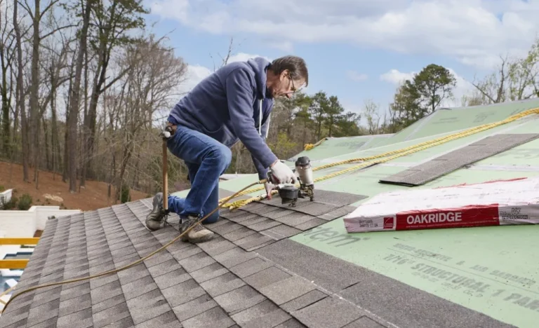 Roofer installing new architectural shingles