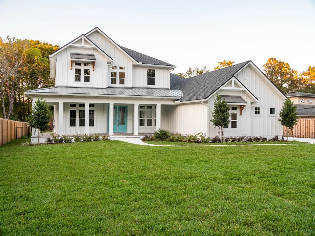 White farmhouse-style home with new windows