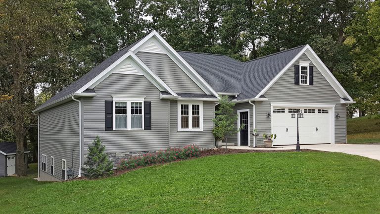 Ranch home with new gray vinyl siding and white trim