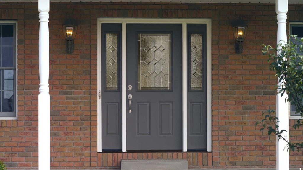 New gray entry door with decorative glass and sidelights
