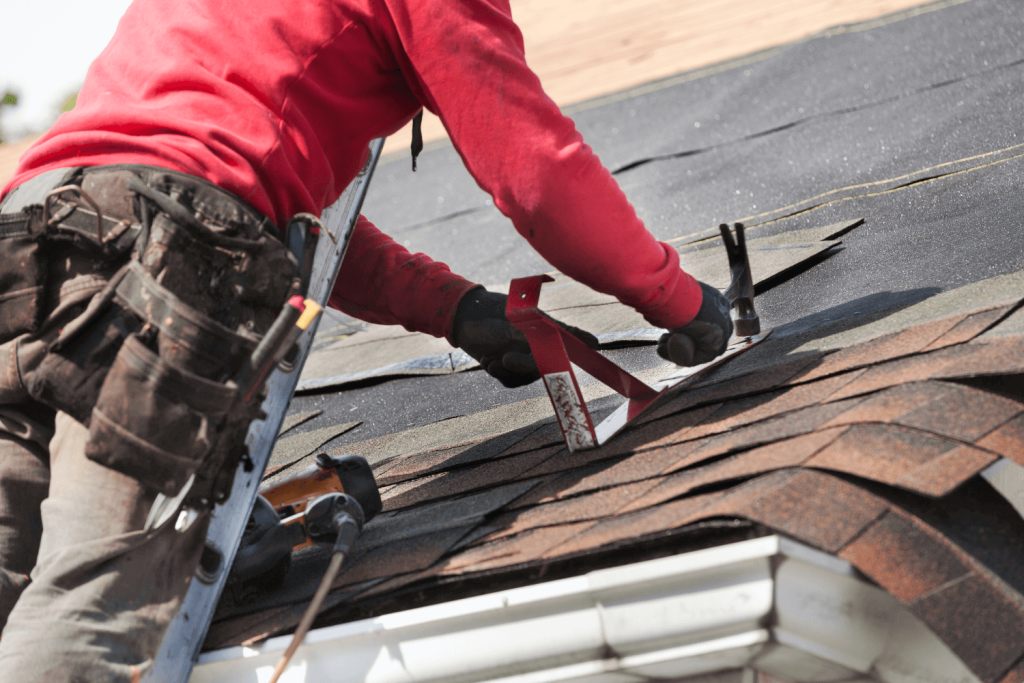 South River NJ 9 Roofer nailing down new asphalt shingles