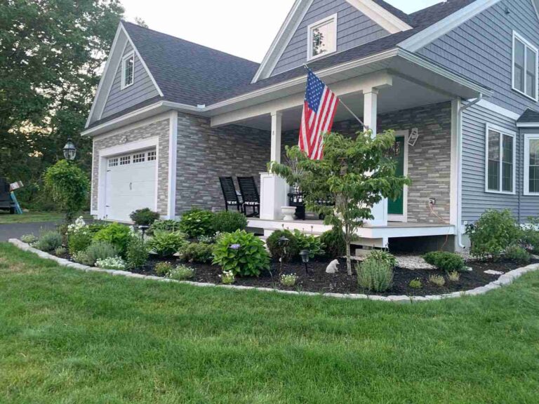 Keansburg NJ 13 Home with stacked stone accents, gray siding and a front porch