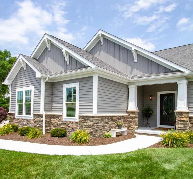 Craftsman-style home with new gray siding and stone accents