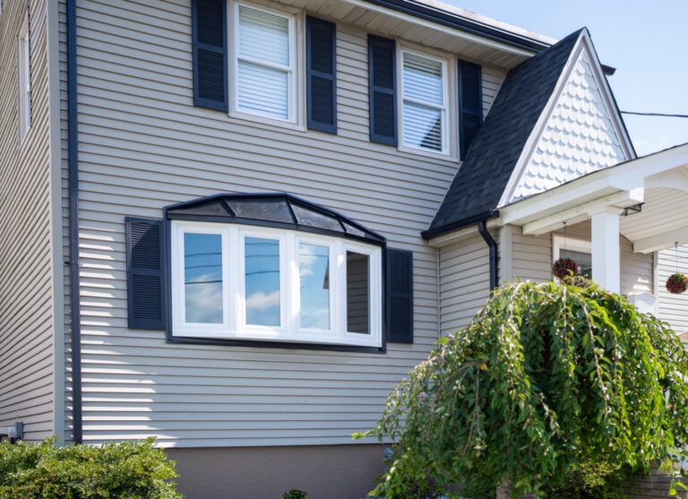 Gray colonial with a new white bay window and black shutters in Union, NJ