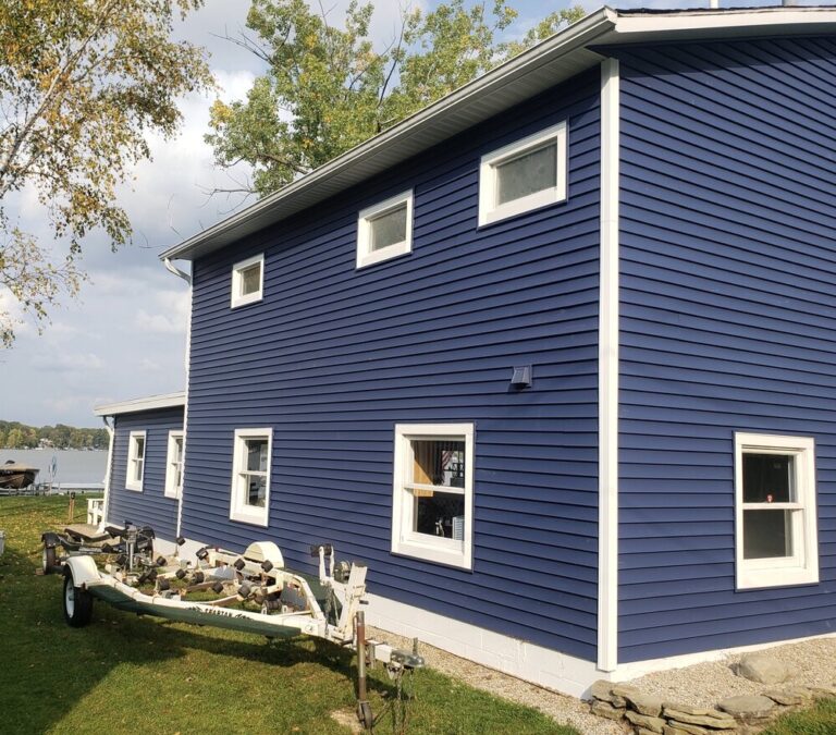 New navy blue vinyl siding with white trim on a two-story home in Eatontown, NJ