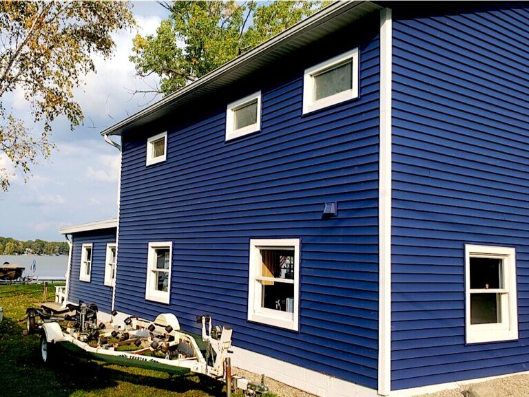 New navy blue vinyl siding with white trim on a two-story home in Eatontown, NJ