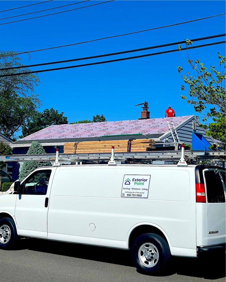 Exterior Point van parked outside a roof replacement in progress in Freehold, NJ