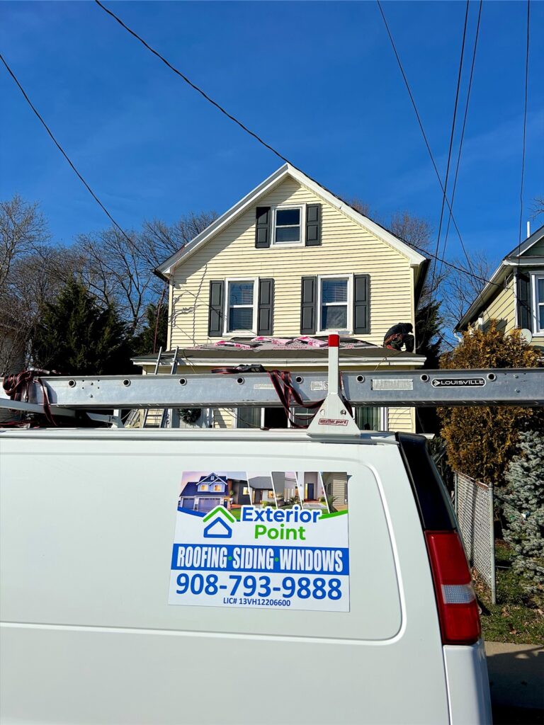 Exterior Point van outside a cream colonial during a roof replacement in Red Bank, NJ