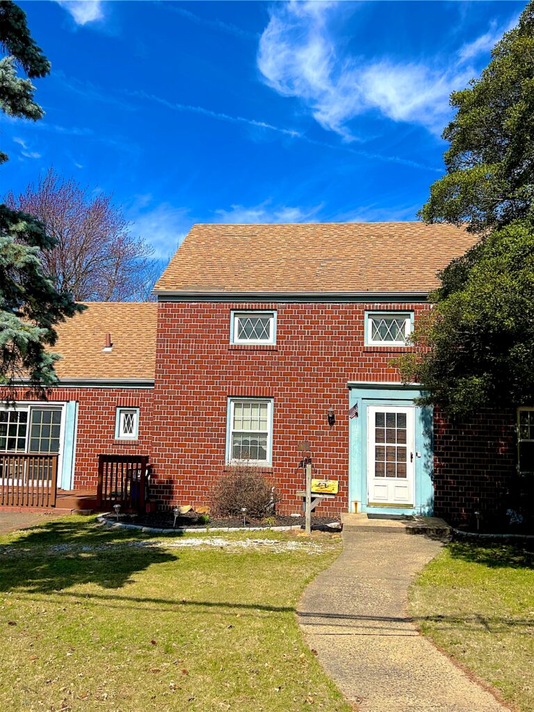 Exterior Point yard sign in front of a brick colonial with a new roof in Sayreville, NJ
