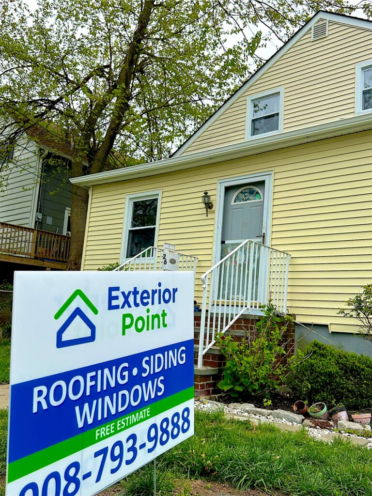 Exterior Point yard sign in front of a yellow Cape Cod in North Middletown, NJ