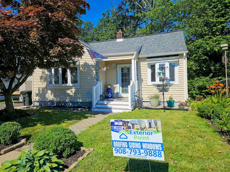 Exterior Point yard sign in front of a tan Cape Cod with a new roof in Keyport, NJ
