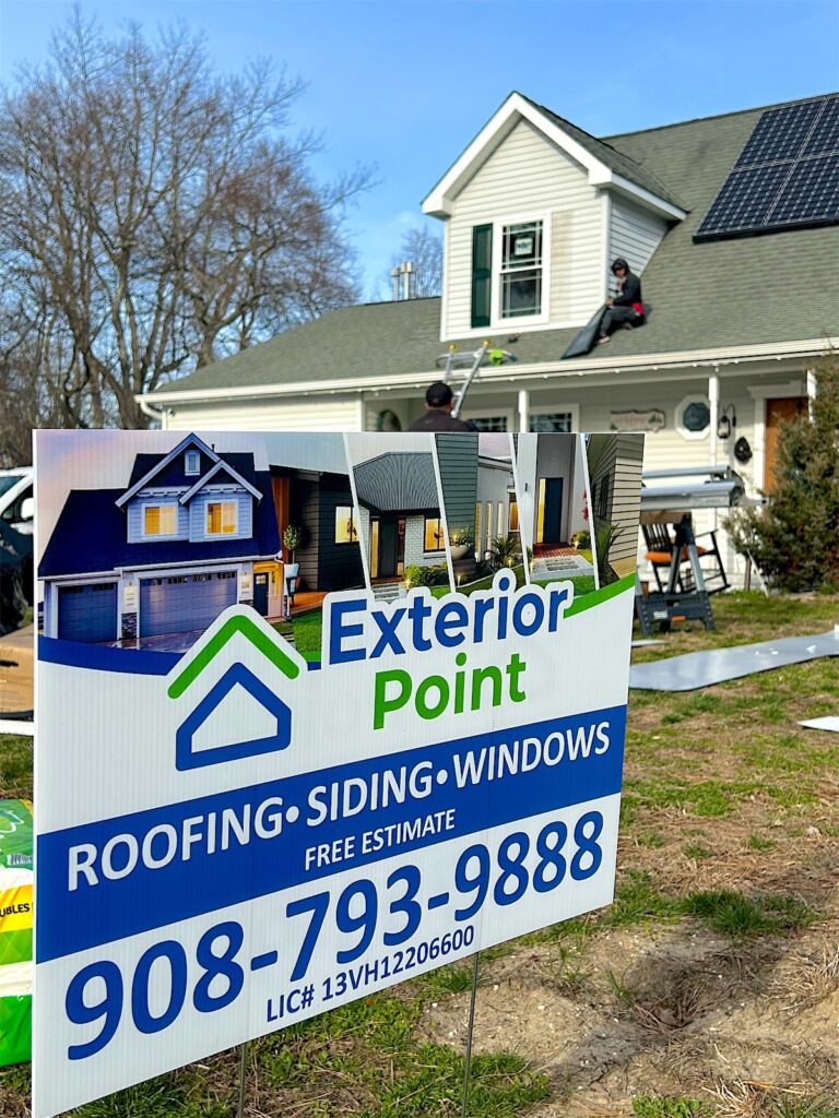 Exterior Point roofing, siding and windows yard sign in front of a home in Manchester, NJ