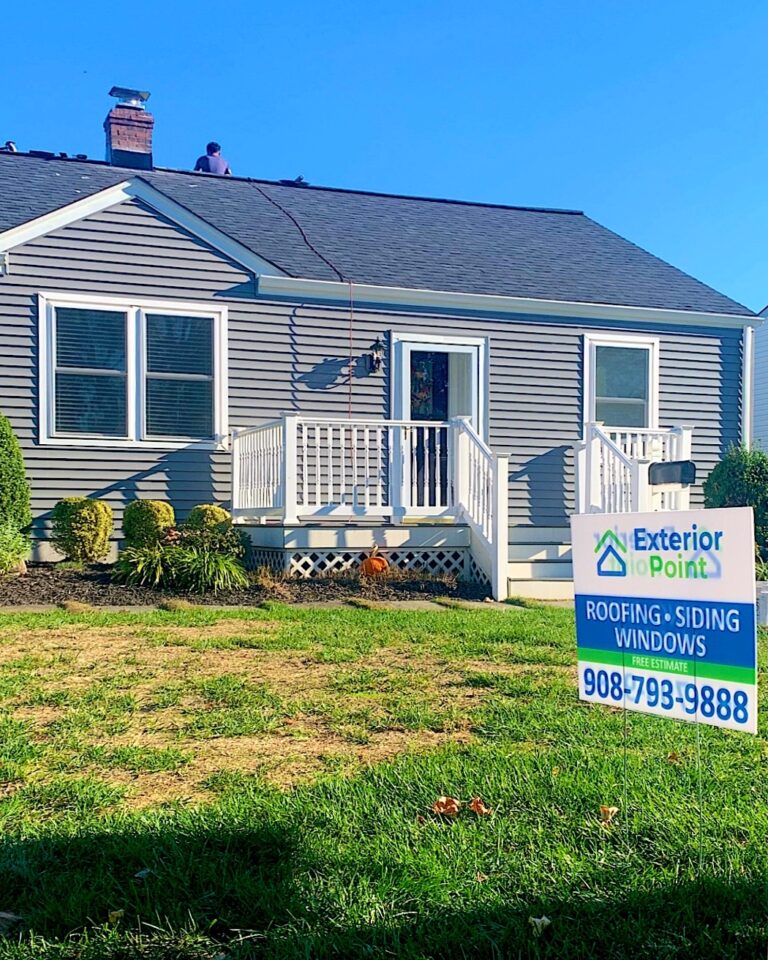 Gray ranch home with a new roof and an Exterior Point yard sign in Oceanport, NJ