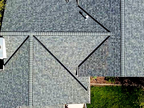 Aerial view of a new architectural shingle roof with hips and valleys