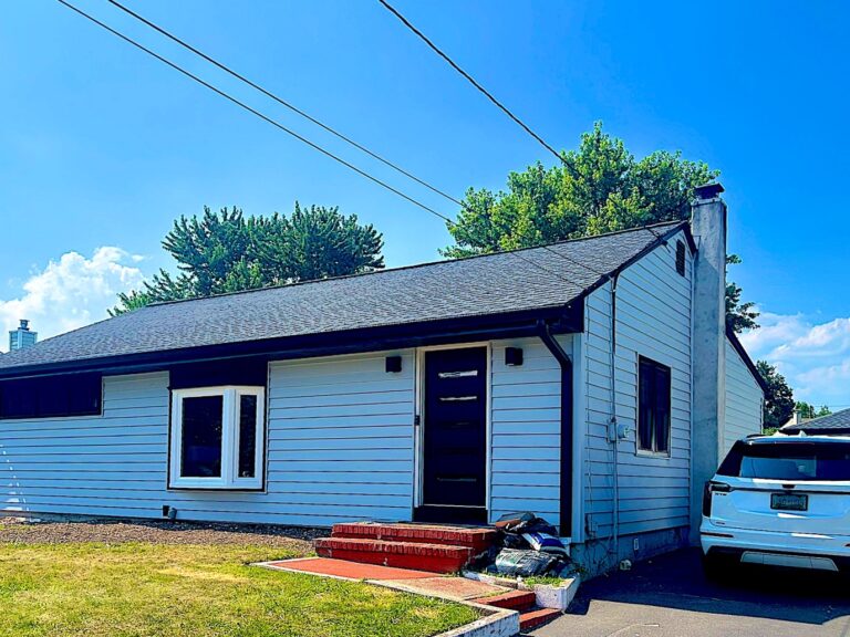 Millstone Township NJ 4 Ranch home with new light blue siding and black windows in Clark, NJ