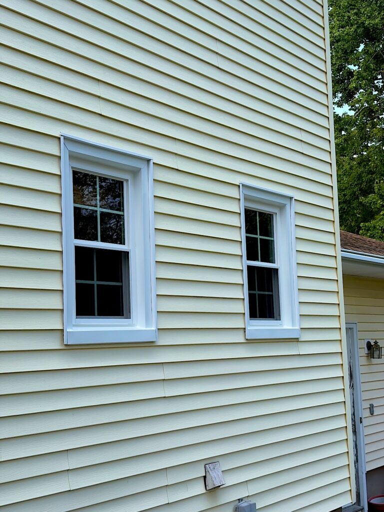 New white replacement windows in gray siding on a home in Lincroft, NJ