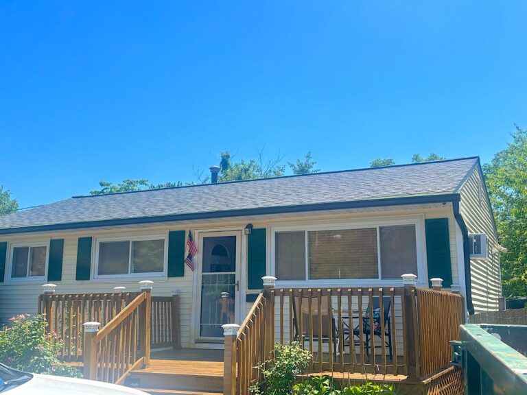 New gray shingle roof on a ranch home with a wood deck in Toms River, NJ