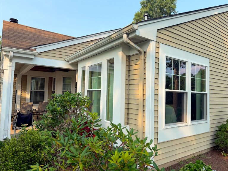 New white double-hung windows on a tan-sided home in Manchester, NJ
