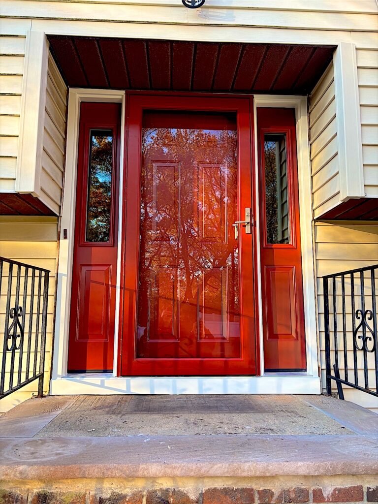 New wood-grain entry door with glass sidelights