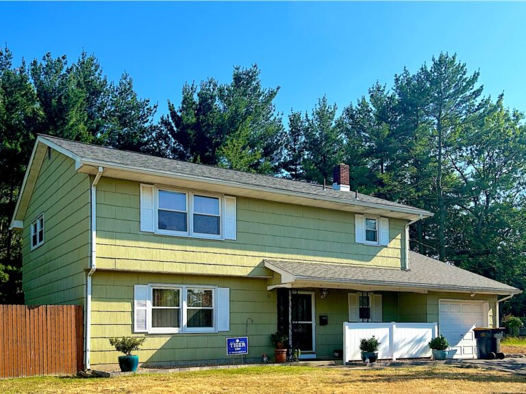Colonial with new yellow siding in Spotswood, NJ